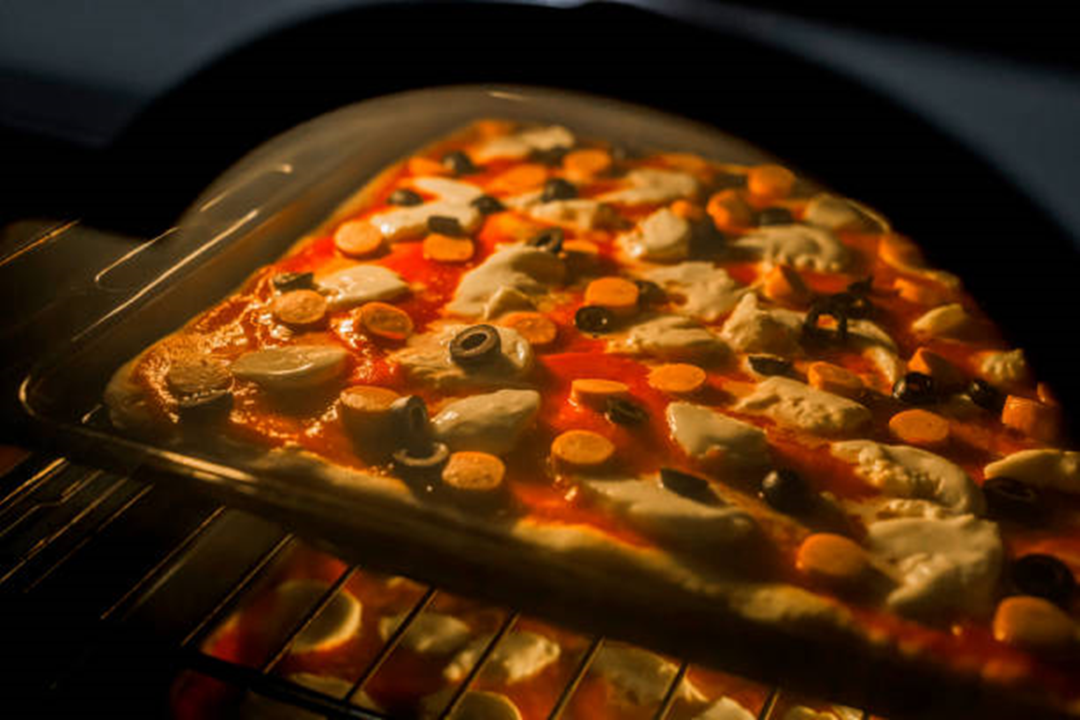 Delicious Sausage and Mozzarella Pizza in oven baking