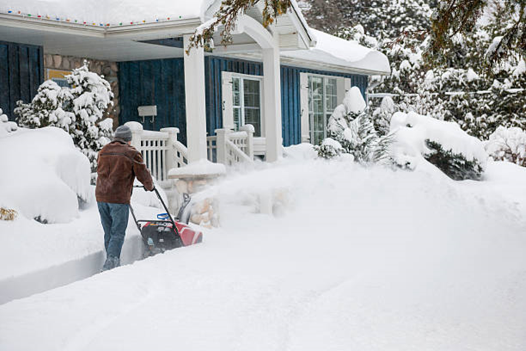 Large snow being cleared with a snow blower for elderly.